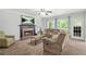 Inviting living room with a brick fireplace, neutral decor, and large windows providing ample natural light at 3059 Brookgreen Trl, Lawrenceville, GA 30043