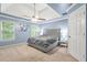 Comfortable main bedroom with tray ceiling, fan, and ample natural light at 3059 Brookgreen Trl, Lawrenceville, GA 30043