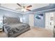 Spacious main bedroom with carpet, fan, ensuite bathroom, and ample natural light at 3059 Brookgreen Trl, Lawrenceville, GA 30043
