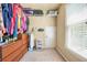 This walk-in closet offers a window and ample shelving and storage space for clothes and personal items at 3059 Brookgreen Trl, Lawrenceville, GA 30043