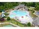 Community pool and surrounding grounds feature water slide, splash pad, lounge chairs, and gazebo at 4317 Azalea Ridge Way, Hoschton, GA 30548