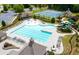 Aerial view of large community swimming pool with beach entry, splash pad, water slide, and tennis court at 4317 Azalea Ridge Way, Hoschton, GA 30548