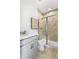 Updated bathroom featuring a single sink vanity, tile flooring and walk-in shower at 4317 Azalea Ridge Way, Hoschton, GA 30548