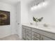 Bright bathroom featuring a double vanity, granite counters, stylish fixtures, and modern mirror at 4317 Azalea Ridge Way, Hoschton, GA 30548
