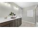 Modern bathroom with double sink vanity, tiled floors, and a glass-enclosed shower at 4317 Azalea Ridge Way, Hoschton, GA 30548