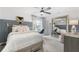 Stylish bedroom with a ceiling fan, desk, and large mirror, filled with natural light at 4317 Azalea Ridge Way, Hoschton, GA 30548