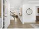 Bright foyer with wood floors, a decorative mirror, and artwork, leading into the home's living spaces at 4317 Azalea Ridge Way, Hoschton, GA 30548