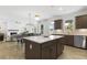 Modern kitchen with a center island, stainless steel appliances, and bright lighting at 4317 Azalea Ridge Way, Hoschton, GA 30548