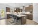Stylish kitchen with stainless appliances, center island, and gray cabinets with modern fixtures at 4317 Azalea Ridge Way, Hoschton, GA 30548