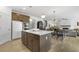 Bright, open kitchen with stainless steel appliances, large island, and pendant lighting at 4317 Azalea Ridge Way, Hoschton, GA 30548