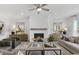 Bright, inviting living room with a fireplace, stylish furnishings, and a ceiling fan for added comfort at 4317 Azalea Ridge Way, Hoschton, GA 30548
