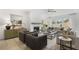 Open-concept living area featuring a modern fireplace, designer furniture, and large windows at 4317 Azalea Ridge Way, Hoschton, GA 30548
