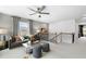 Upstairs loft featuring stylish seating, natural light, and stairway access at 4317 Azalea Ridge Way, Hoschton, GA 30548