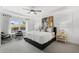 Spacious main bedroom featuring tray ceilings, a ceiling fan, stylish decor, and large windows at 4317 Azalea Ridge Way, Hoschton, GA 30548