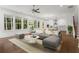 Open-concept living room seamlessly connects to the kitchen, featuring hardwood floors and abundant natural light at 779 Keystone Dr, Woodstock, GA 30188