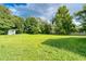 Spacious backyard featuring lush greenery and a convenient storage shed at 1997 Villa Rica Hwy, Dallas, GA 30157