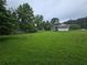 Expansive backyard with plenty of green space and a screened-in porch at 1997 Villa Rica Hwy, Dallas, GA 30157
