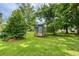 Lush backyard featuring mature trees and a wooden shed at 1997 Villa Rica Hwy, Dallas, GA 30157