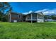 A large backyard featuring both a brick and vinyl extension of the home at 1997 Villa Rica Hwy, Dallas, GA 30157