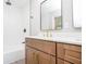 Bathroom showing a shower and tub combination with a wood vanity and elegant matte black fixtures at 1997 Villa Rica Hwy, Dallas, GA 30157