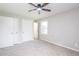This is a bedroom with fresh paint, neutral carpet, a ceiling fan, and a window at 1997 Villa Rica Hwy, Dallas, GA 30157