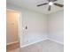 A cozy bedroom featuring neutral walls, carpet flooring, a ceiling fan, and an open doorway at 1997 Villa Rica Hwy, Dallas, GA 30157