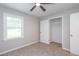 Bedroom featuring a window view, an open closet for storage, and a neutral color scheme for a relaxing ambiance at 1997 Villa Rica Hwy, Dallas, GA 30157