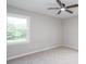 This bright bedroom features a ceiling fan and a large window providing natural light at 1997 Villa Rica Hwy, Dallas, GA 30157