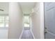 Hallway leading into a bright, carpeted room with a large window, showcasing neutral colors and a clean aesthetic at 1997 Villa Rica Hwy, Dallas, GA 30157