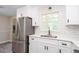 Kitchen with stainless steel appliances, white cabinets and stone countertops at 1997 Villa Rica Hwy, Dallas, GA 30157