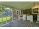 A screened porch overlooks a grassy backyard with storage cabinets on one side at 1997 Villa Rica Hwy, Dallas, GA 30157