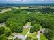 Aerial view of a traditional home surrounded by a lush, green forest and a well-manicured lawn at 2680 Bay Ridge Dr, Loganville, GA 30052