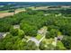 Aerial view of a traditional home surrounded by a lush, green forest and a well-manicured lawn at 2680 Bay Ridge Dr, Loganville, GA 30052