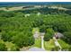 Aerial view of a traditional home surrounded by a lush, green forest and a well-manicured lawn at 2680 Bay Ridge Dr, Loganville, GA 30052