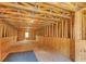 Unfinished attic with wood beams, flooring and natural light entering from the lone window at 2680 Bay Ridge Dr, Loganville, GA 30052