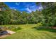 Expansive backyard features lush green grass and a backdrop of mature trees at 2680 Bay Ridge Dr, Loganville, GA 30052