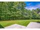 Large, manicured backyard with view to the trees at 2680 Bay Ridge Dr, Loganville, GA 30052