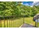 View from the balcony showcasing a well-maintained green lawn and mature trees in the background at 2680 Bay Ridge Dr, Loganville, GA 30052