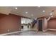 Basement living space with a kitchen, stairs, neutral walls and plank floors at 2680 Bay Ridge Dr, Loganville, GA 30052