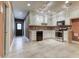 The basement kitchen has white cabinetry, stainless steel appliances, recessed lights, and tile floors at 2680 Bay Ridge Dr, Loganville, GA 30052