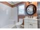 Bathroom featuring a single sink vanity and a shower over the toilet at 2680 Bay Ridge Dr, Loganville, GA 30052