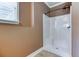 A well-lit shower with a white stand-up shower and tiled floors next to a window at 2680 Bay Ridge Dr, Loganville, GA 30052