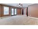 Spacious bedroom featuring neutral carpet, fan, and access to the backyard at 2680 Bay Ridge Dr, Loganville, GA 30052