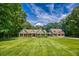 Charming home with a well-manicured lawn, stone accents, and a matching garage building at 2680 Bay Ridge Dr, Loganville, GA 30052