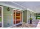 Inviting front door featuring sidelights and transom, with a view of lush greenery at 2680 Bay Ridge Dr, Loganville, GA 30052