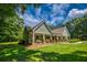 Charming home featuring a well-manicured lawn, stone accents, and a covered front porch at 2680 Bay Ridge Dr, Loganville, GA 30052