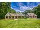 Charming home with a well-manicured lawn, stone accents, and a matching garage building at 2680 Bay Ridge Dr, Loganville, GA 30052