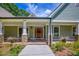 Inviting home featuring stone pillar accents, covered front porch, and well-manicured landscaping at 2680 Bay Ridge Dr, Loganville, GA 30052