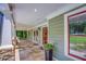 Inviting front porch featuring stone pillar accents and a well-lit entry, with a view of lush greenery at 2680 Bay Ridge Dr, Loganville, GA 30052