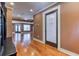 Hallway with hardwood floors, leading to an open living area and a laundry room with a custom door at 2680 Bay Ridge Dr, Loganville, GA 30052